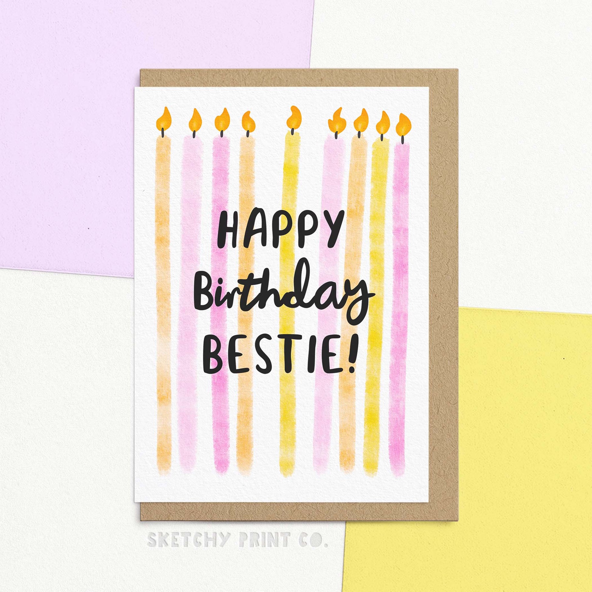 Happy Birthday Bestie greeting card with hand-lettered text, featuring a watercolour illustration of long birthday candles in lilac, soft pink, orange, and butter yellow.