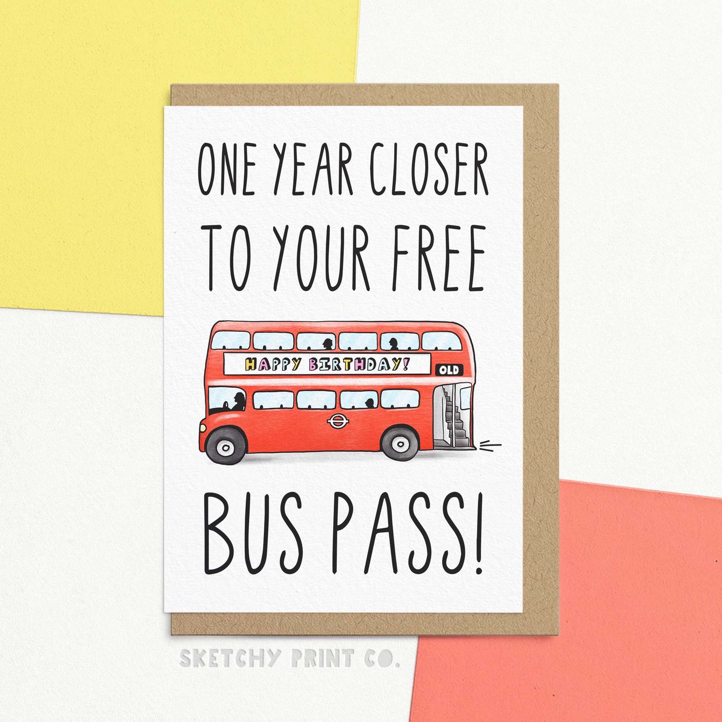 Cheeky birthday card reading 'one year closer to your free bus pass!' in handwritten font. Illustrated with red London bus displaying 'OLD' route number and 'happy birthday' advert. Includes Kraft envelope.