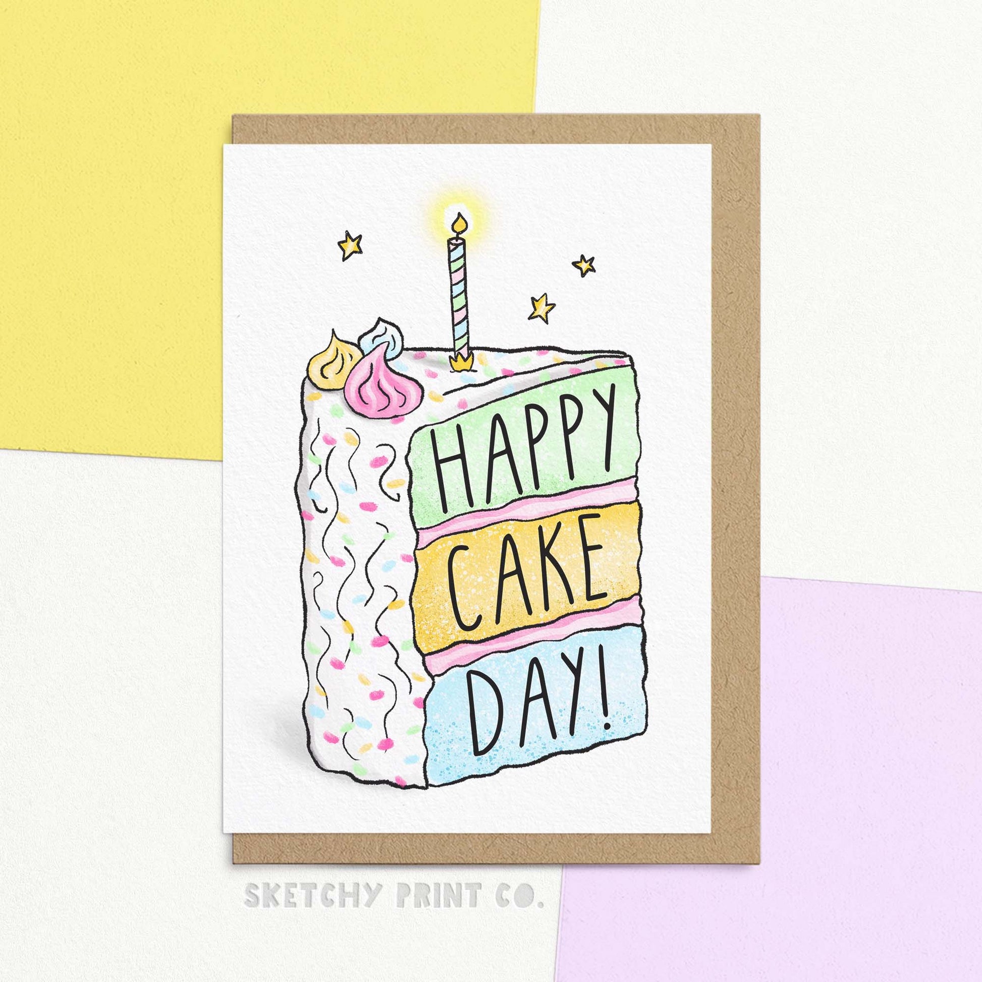 Cute birthday card with illustration of a slice of cake reading 'happy cake day'. Shown with Kraft envelope.