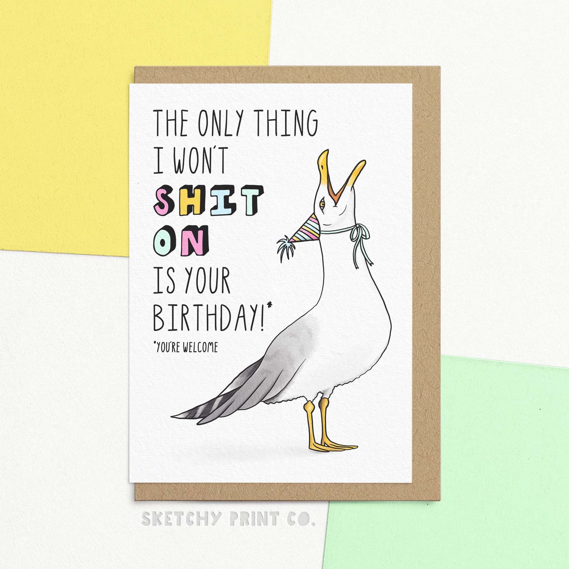 Funny birthday card featuring illustrated seagull and text 'the only thing I won't shit on is your birthday!* *you're welcome'. Shown with a brown Kraft envelope.