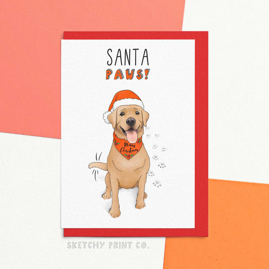 cute Christmas card with an illustration of a red fox Labrador reading Santa paws! Get ready to unleash some holiday cheer with Santa Paws - the cutest Christmas card for dog lovers! With funny Christmas wishes, this card is perfect for spreading some holiday joy to all your dog-loving friends. Get your paws on one today and make everyone bark with laughter.