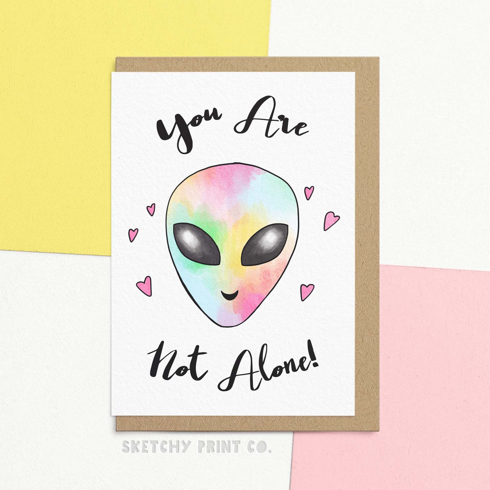 Cute just to say card for struggling friend reading you are not alone with a cute illustration of a pastel rainbow alien and hearts. Let your friend know they're not alone with our cute card. If they are feeling a little alien, let them know that you can be cute rainbow aliens together! Share the love and support they need in a fun and uplifting way, our adorable card comes blank inside for your own personalised message.