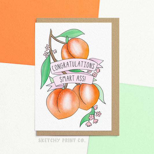 Funny graduation card reading congratulations smart ass! with an illustration of peaches. Congratulate your favourite smart ass with this peachy graduation card! Featuring a cheeky design, this funny card will surely earn a giggle. Perfect for the friend who is both stylish and clever, whether for graduation or passing exams, wish them ass-tronomical success in the future!