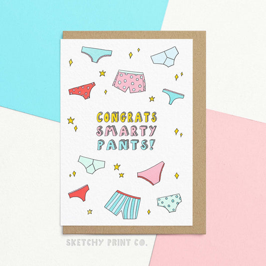 Funny graduation card reading congrats smarty pants! with illustrations of colourful pants and stars. Celebrate their smarts and success with our Smarty Pants graduation card! This funny and cute card is the perfect way to congratulate them on their exam success. With a playful tone and puns galore, this card is sure to bring a smile to their face. (Lucky pants optional!)