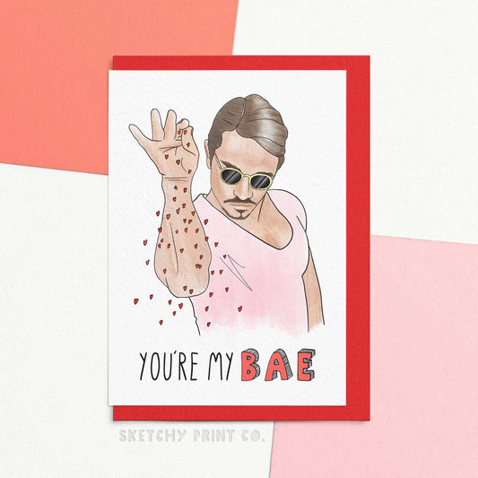 Funny Valentine's Day Card reading You're My Bae! With an illustration of a man sprinkling some love like salt. Spice up your Valentine's Day with this hilarious card that will definitely make your bae chuckle. With a playful nod to both love and food, this is the perfect funny Valentine's Day card for your foodie lover. Go ahead and sprinkle some love with this one-of-a-kind card!